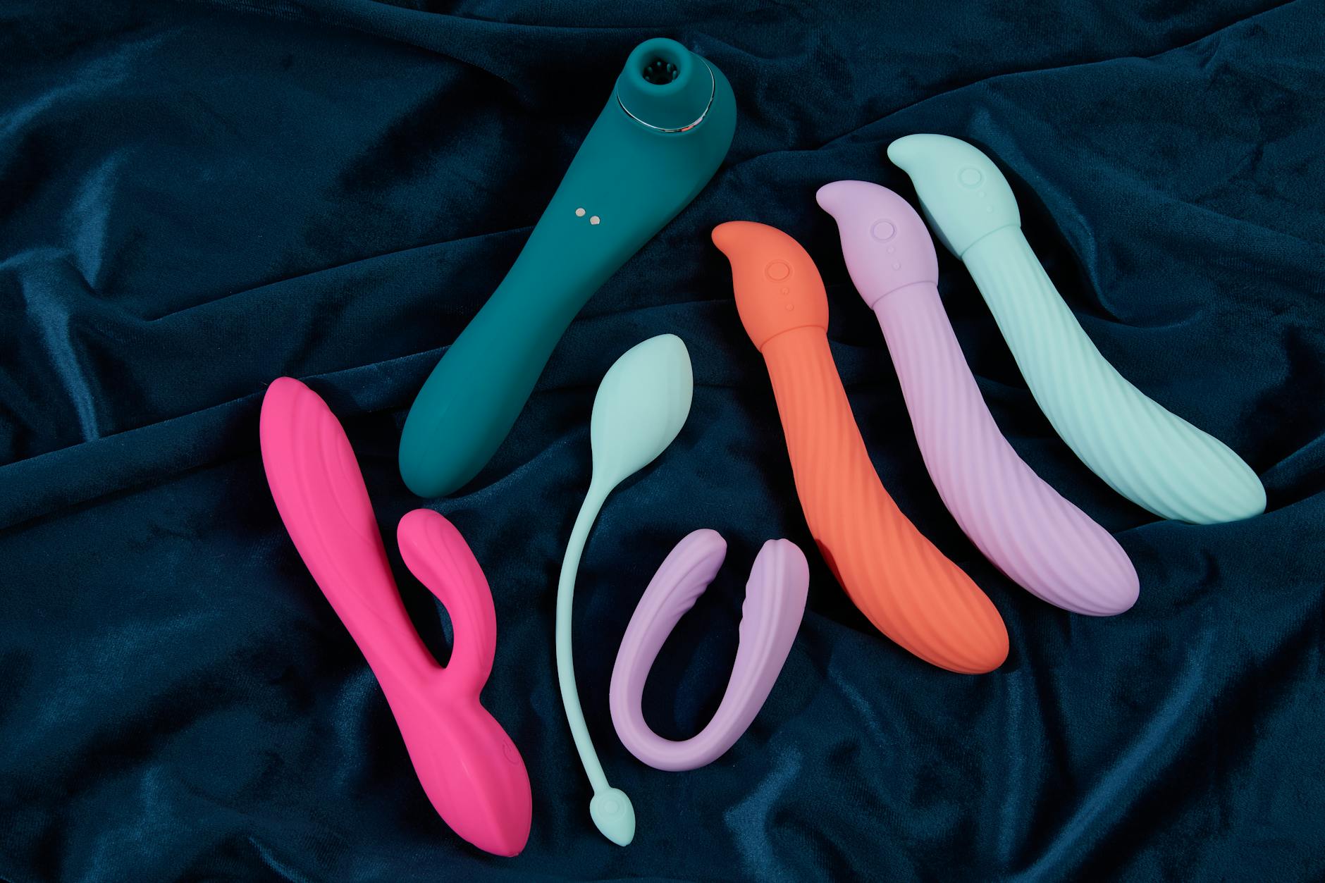 A young couple standing together, holding a blue vibrator, symbolizing modern shared intimacy