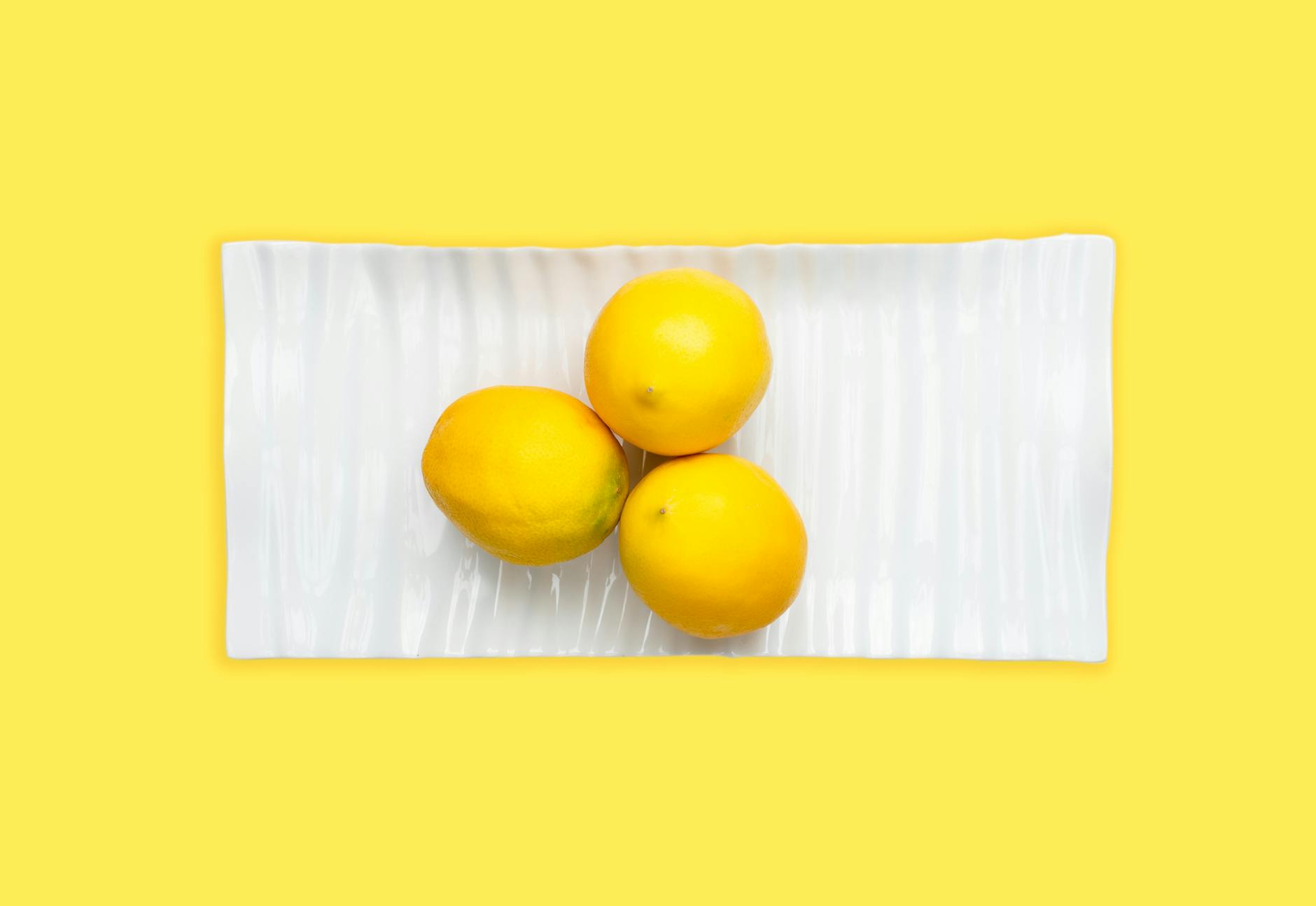 Person holding a fresh lemon, grounded and present
