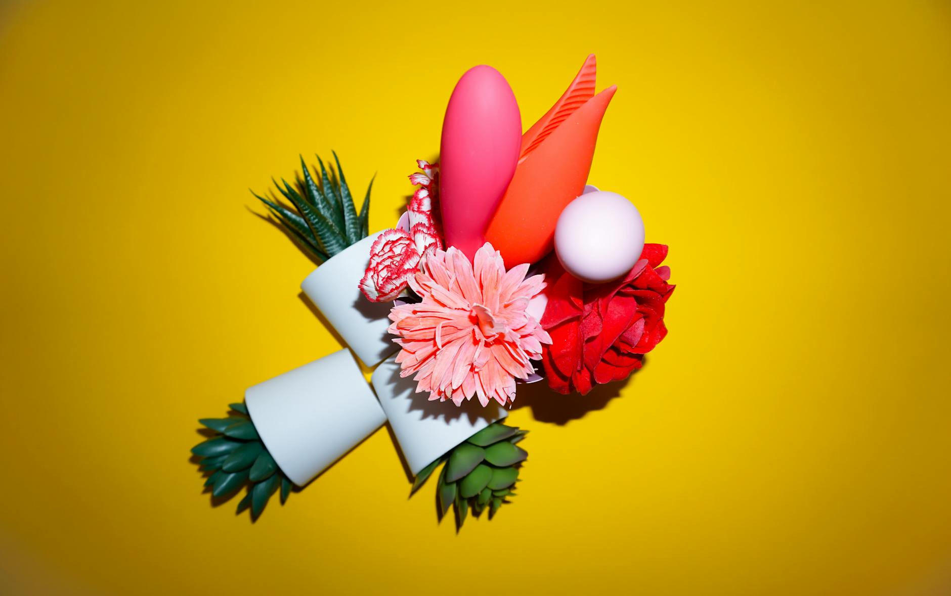 Yellow lemon vibrator surrounded by bananas on a yellow background, symbolizing fresh start and natural pleasure