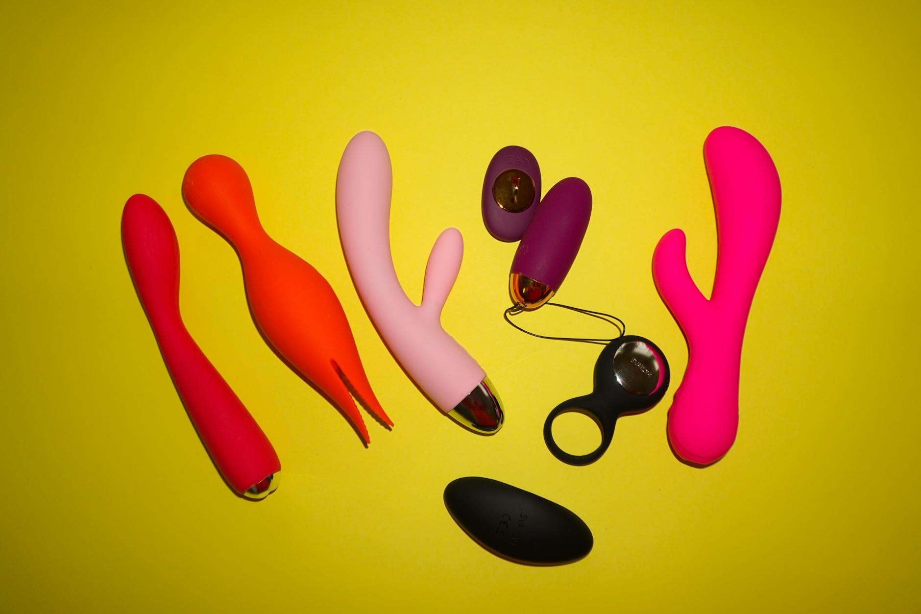 Woman holding a vibrator surrounded by art books, representing intimacy and sensual discovery