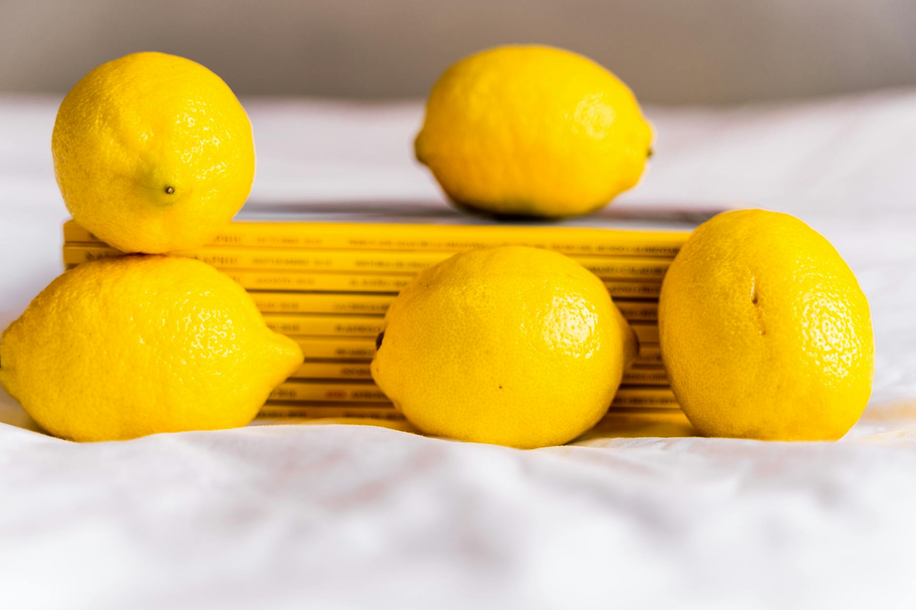 Fresh lemons arranged with books, symbolizing natural approaches to pleasure and wellness